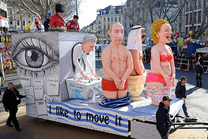 A carnival float shows Wikileaks' Julian Assange dropping the trousers of Wladimir Putin of Russia, King Abdullah of Saudi Arabia and State Secretary Hillary Clinton of the US during the traditional Rosemonday carnival parade in Cologne, Germany, Monday, March 7, 2011.  The Rosemonday parade in Cologne, visited by one million spectators, is one of the highlights of the street carnival season. (AP Photo/Martin Meissner)